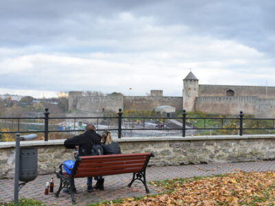 A couple enjoying privacy in the riverine park with views of Ivangorod Fortress and Russia.